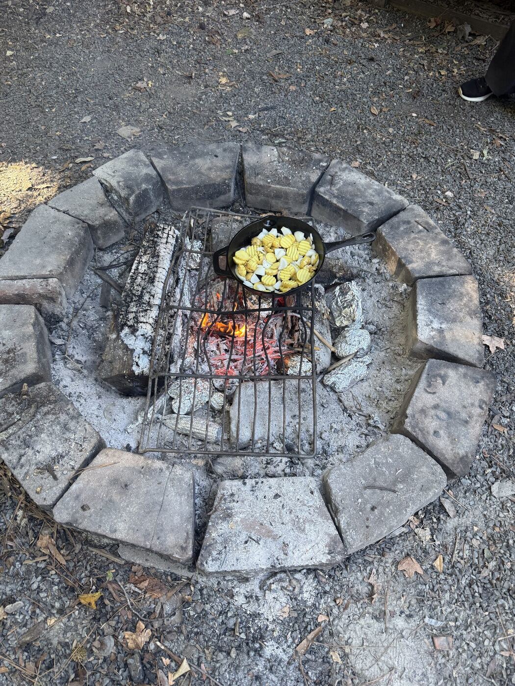 A cast iron pan over the fire pit