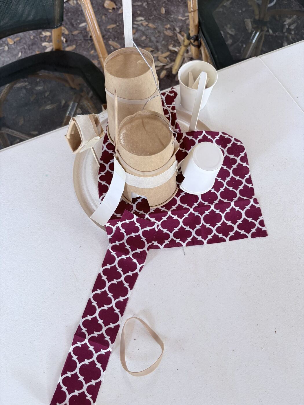A small house built from paper cups, card and patterned fabric