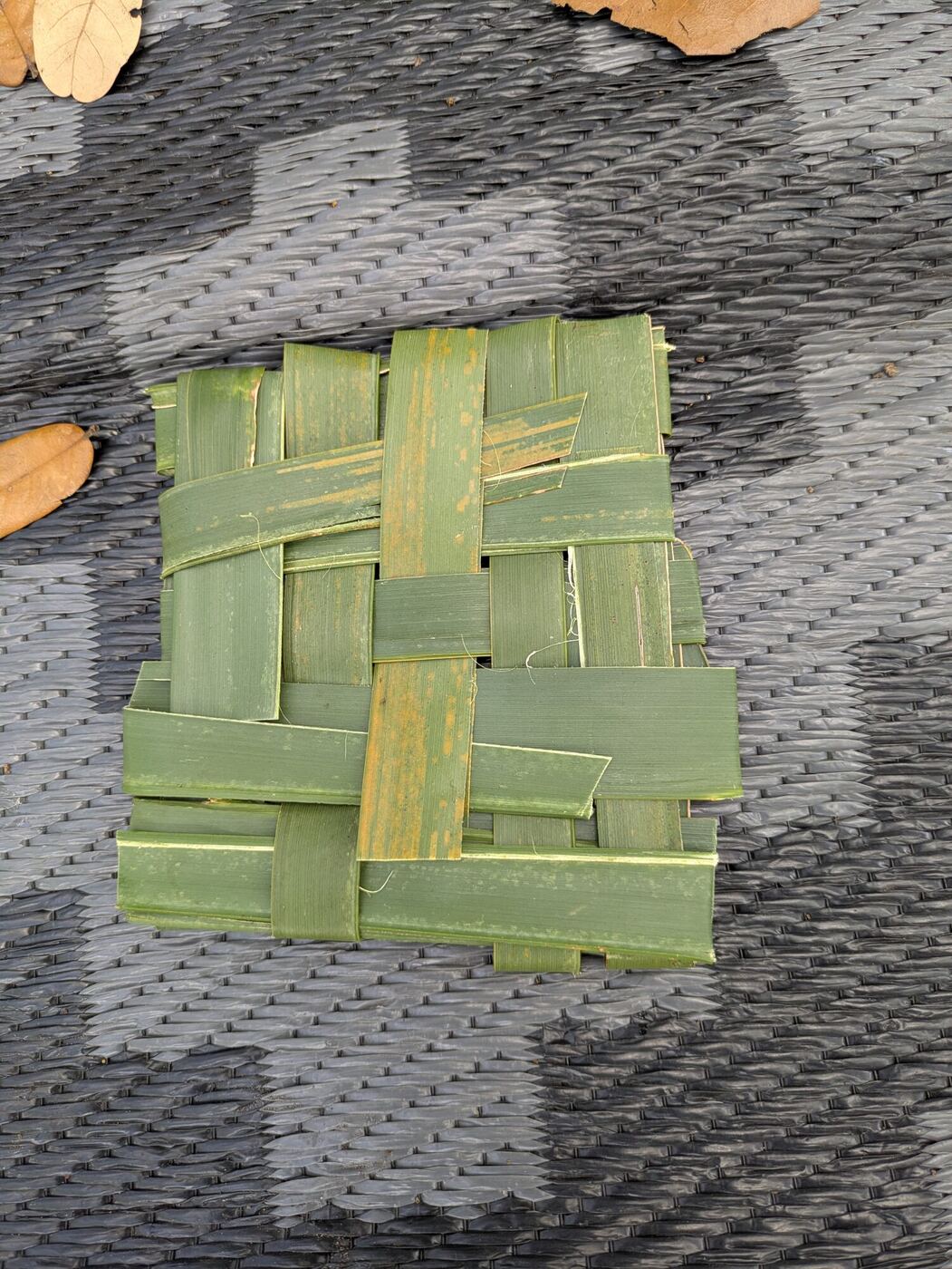 A small mat woven from palmetto fronds