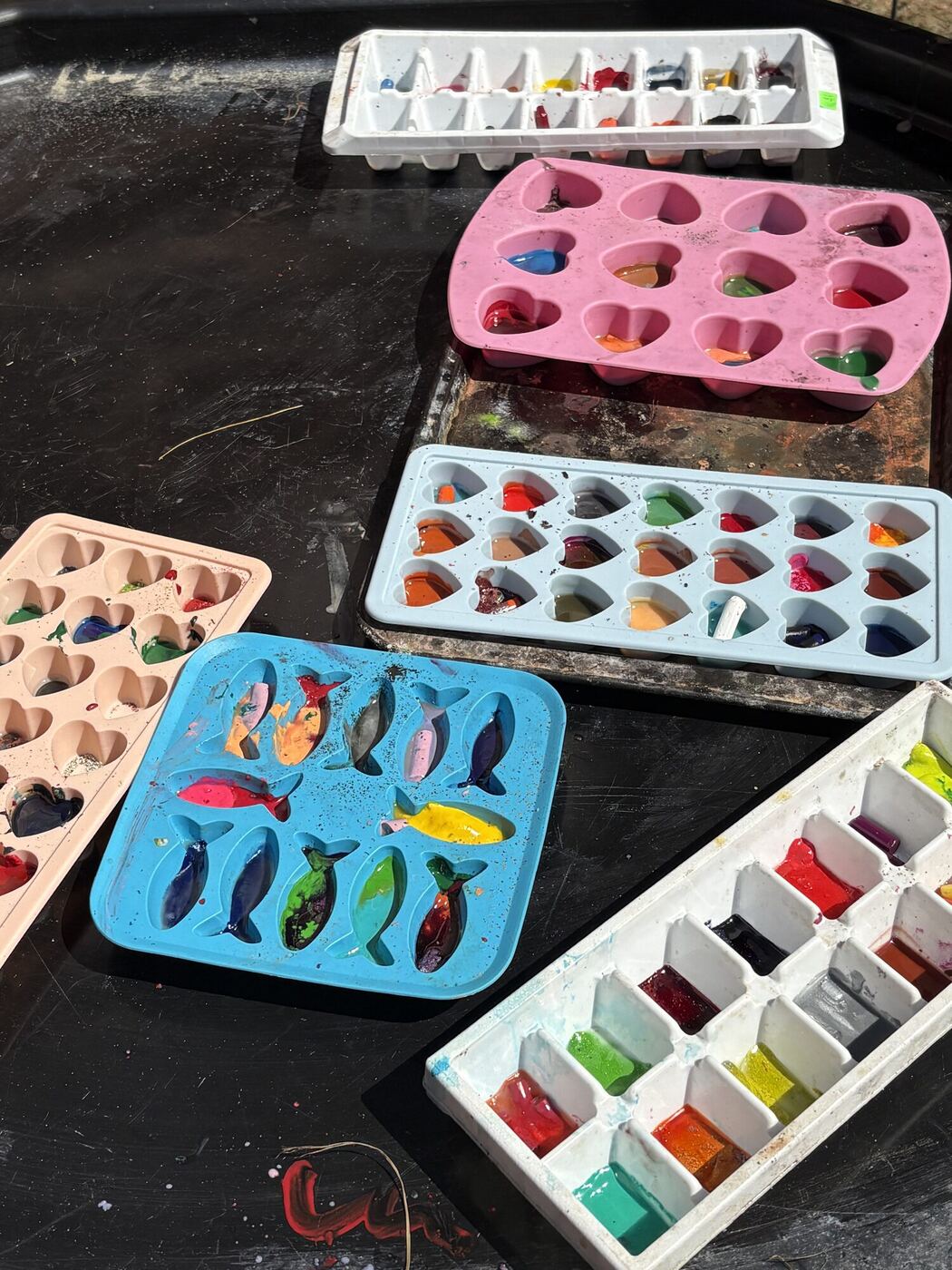 Crayon pieces in heart and fish molds, ready to melt