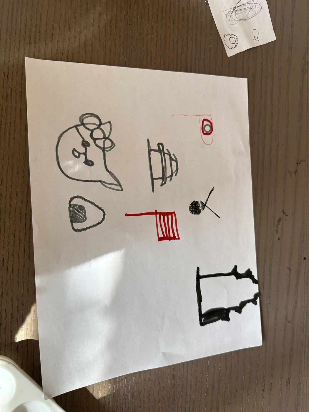 A sheet of paper from the drawing game, each player's marks in a different pen