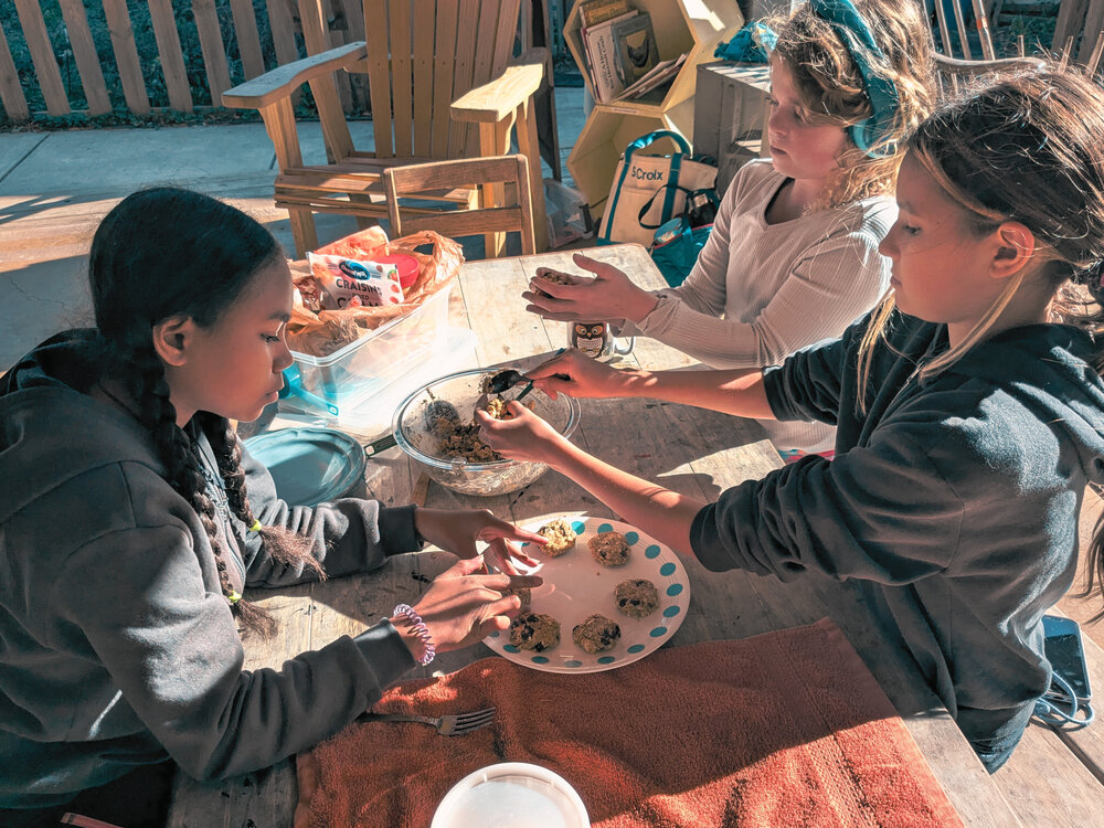 Children collaborating on baking cookies together